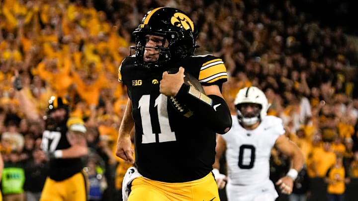 Iowa Hawkeyes quarterback Mark Gronowski (11) carries the ball down field during a college football game against the Penn State Nittany Lions Oct. 18, 2025 at Kinnick Stadium in Iowa City, Iowa. Iowa Hawkeyes quarterback Mark Gronowski (11) carries the ball down field during a college football game against the Penn State Nittany Lions Oct. 18, 2025 at Kinnick Stadium in Iowa City, Iowa.