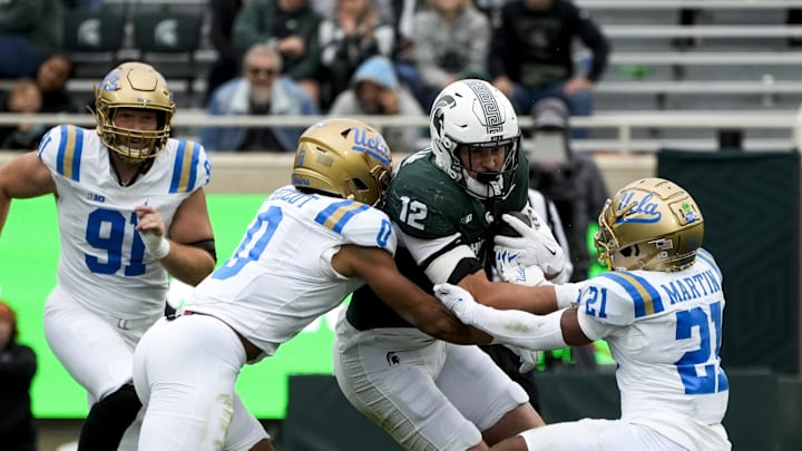 Oct 11, 2025; East Lansing, Michigan, USA; Michigan State tight end Jack Velling (12) runs through the UCLA Bruins defense in the fourth quarter at Spartan Stadium. Mandatory Credit: Brendan Mullin-Imagn Images