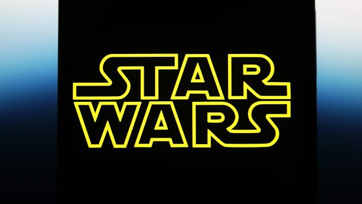 In this photo illustration, a Star Wars logo is seen on a...