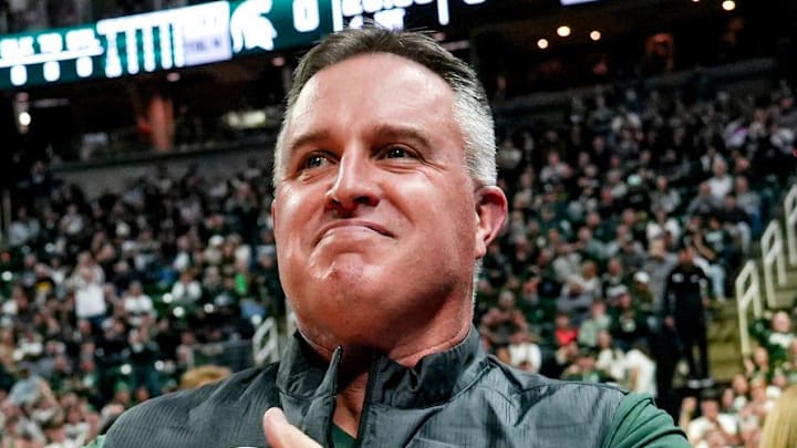 Michigan State's new football coach Pat Fitzgerald pats his heart at the crowd in attendance for the Spartans basketball game against Iowa on Tuesday, Dec. 2, 2025, at the Breslin Center in East Lansing.