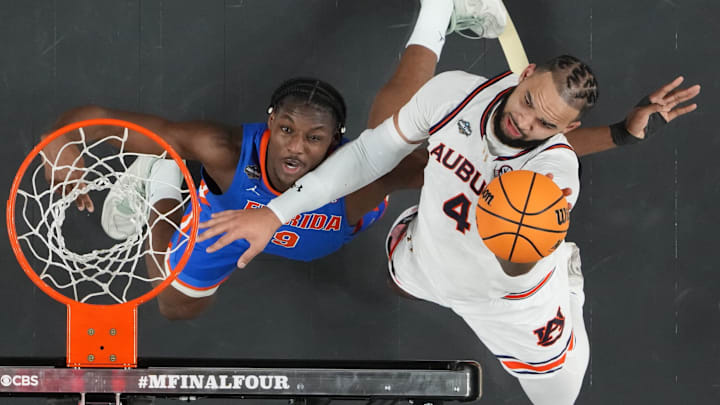 Apr 5, 2025; San Antonio, TX, USA;  Auburn Tigers forward Johni Broome (4) shoots against Florida Gators center Rueben Chinyelu (9) in the semifinals of the men's Final Four of the 2025 NCAA Tournament at the Alamodome. Mandatory Credit: Robert Deutsch-Imagn Images