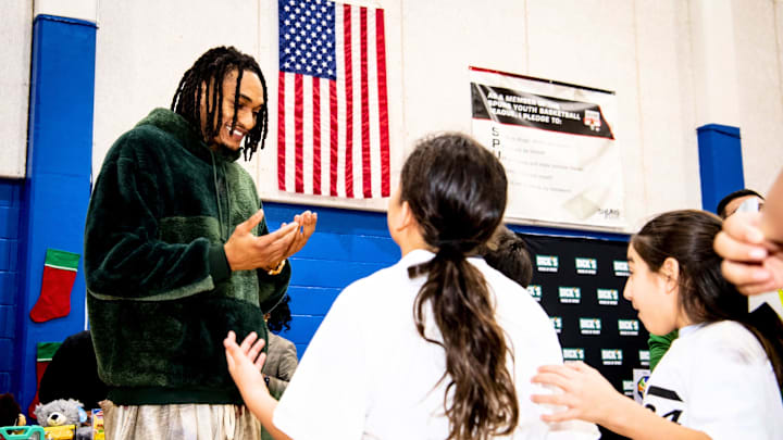 Dec 17, 2025; San Antonio, Texas, USA; San Antonio Spurs shooting guard Devin Vassell (24) talks with kids during his Holiday Extravaganza at the Boys & Girls Club of Greater San Antonio.
