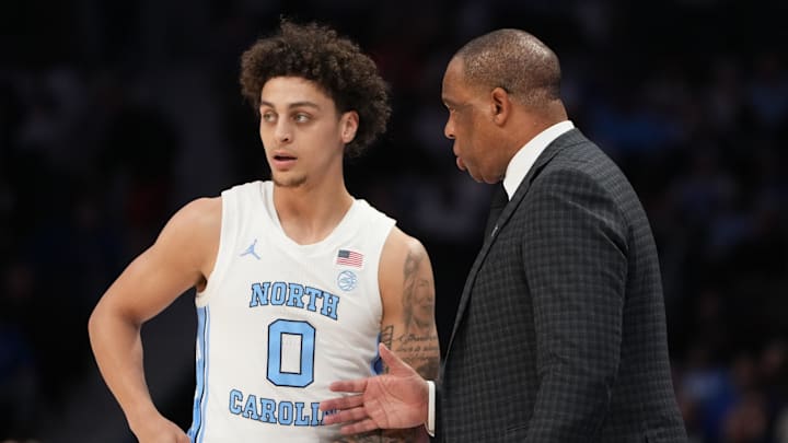 Mar 12, 2026; Charlotte, NC, USA; North Carolina Tar Heels head coach Hubert Davis with guard Kyan Evans (0) in the first half at Spectrum Center. Mandatory Credit: Bob Donnan-Imagn Images
