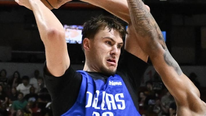 Jul 12, 2025; Las Vegas, NV, USA; Dallas Mavericks forward Cooper Flagg (32) passes the ball against San Antonio Spurs center Nathan Mensah (31) and guard Dylan Harper (2) in the third quarter of their game at Thomas & Mack Center. Mandatory Credit: Candice Ward-Imagn Images Jul 12, 2025; Las Vegas, NV, USA; Dallas Mavericks forward Cooper Flagg (32) passes the ball against San Antonio Spurs center Nathan Mensah (31) and guard Dylan Harper (2) in the third quarter of their game at Thomas & Mack Center. Mandatory Credit: Candice Ward-Imagn Images