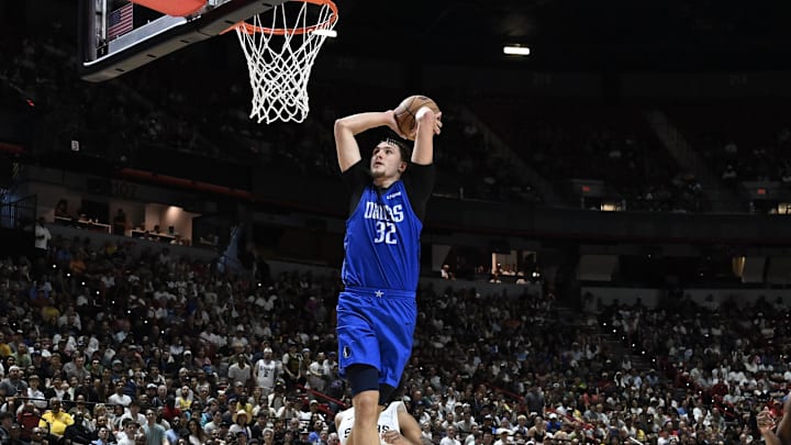 Jul 12, 2025; Las Vegas, NV, USA; Dallas Mavericks forward Cooper Flagg (32) dunks against the San Antonio Spurs in the fourth quarter of their game at Thomas & Mack Center. Mandatory Credit: Candice Ward-Imagn Images