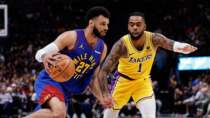 Oct 24, 2023; Denver, Colorado, USA; Denver Nuggets guard Jamal Murray (27) controls the ball as Los Angeles Lakers guard D'Angelo Russell (1) guards in the second quarter at Ball Arena.