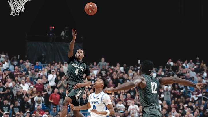 Frisco Heritage's Cameron Lomax (4) throws an alley-oop pass to Bryson Howard (12) during the Class 5A Division 1 finals. Both were named to the TABC All-Tournament team. 