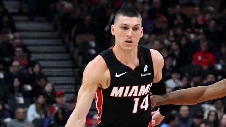 Dec 1, 2024; Toronto, Ontario, CAN; Miami Heat guard Tyler Herro (14) dribbles the ball past Toronto Raptors guard Ochai Agbaji (30) in the first half at Scotiabank Arena. Mandatory Credit: Dan Hamilton-Imagn Images