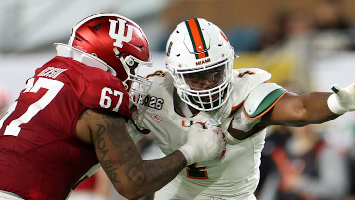Jan 19, 2026; Miami Gardens, FL, USA; Indiana Hoosiers offensive lineman Kahlil Benson (67) attempts to block Miami Hurricanes defensive lineman Rueben Bain Jr. (4) in the first half during the College Football Playoff National Championship game at Hard Rock Stadium. Mandatory Credit: Nathan Ray Seebeck-Imagn Images