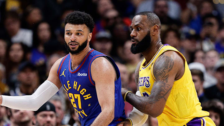 Oct 24, 2023; Denver, Colorado, USA; Denver Nuggets guard Jamal Murray (27) controls the ball as Los Angeles Lakers forward LeBron James (23) guards in the third quarter at Ball Arena.