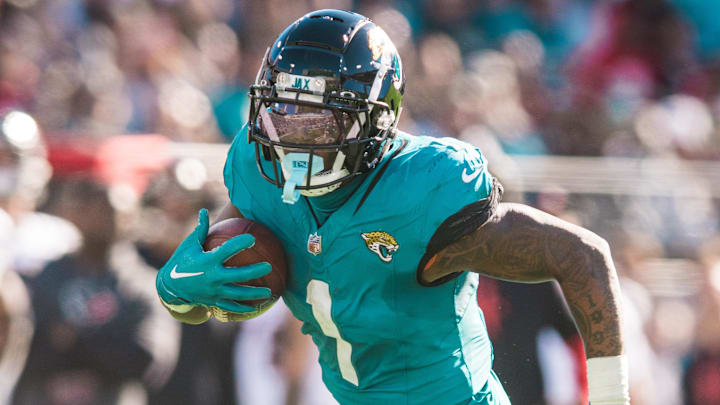 Dec 1, 2024; Jacksonville, Florida, USA; Jacksonville Jaguars running back Travis Etienne Jr (1) runs the ball against the Houston Texans in the second quarter at EverBank Stadium. Mandatory Credit: Jeremy Reper-Imagn Images Dec 1, 2024; Jacksonville, Florida, USA; Jacksonville Jaguars running back Travis Etienne Jr (1) runs the ball against the Houston Texans in the second quarter at EverBank Stadium. Mandatory Credit: Jeremy Reper-Imagn Images