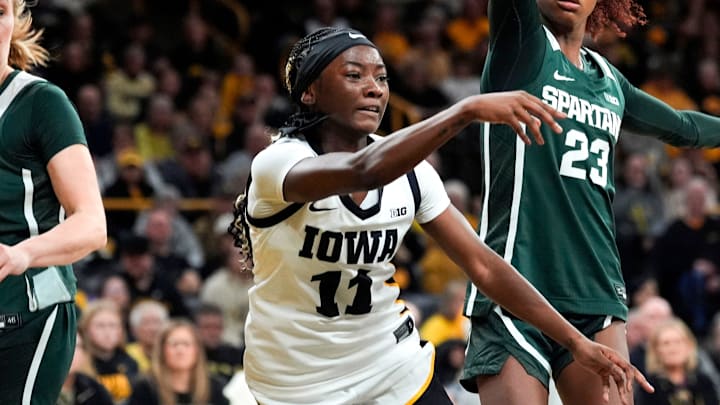 Iowa guard Chit-Chat Wright (11) passes the basketball as Michigan State guard Jalyn Brown (23) defends Jan. 18, 2026 at Carver-Hawkeye Arena in Iowa City, Iowa.