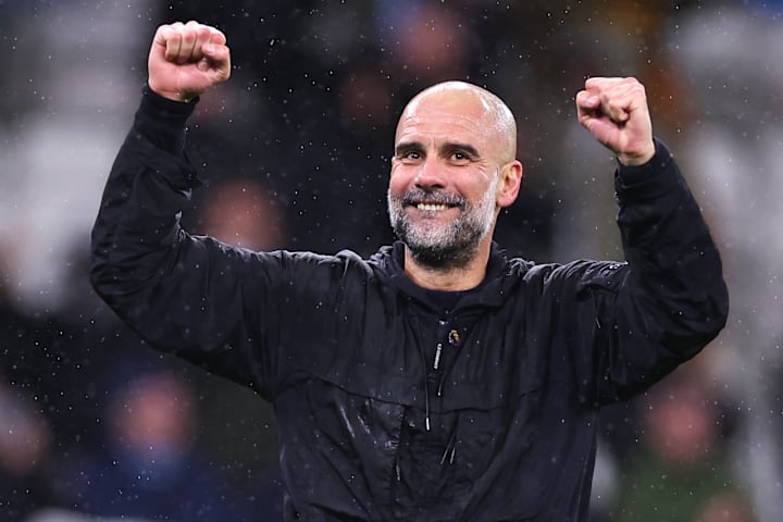 Pep Guardiola celebrates with Manchester City's supporters after defeating Newcastle