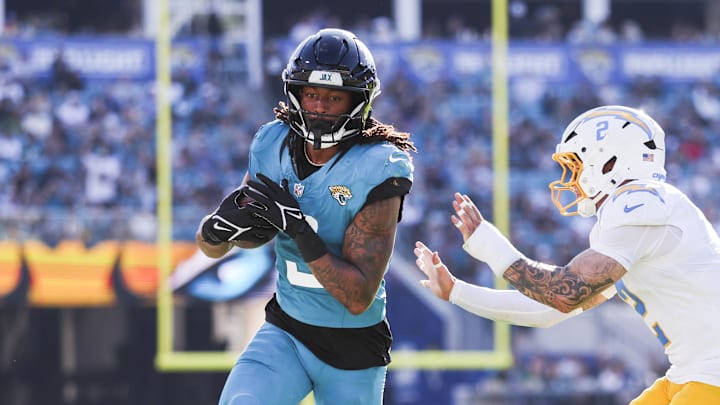 Nov 16, 2025; Jacksonville, Florida, USA; Jacksonville Jaguars wide receiver Jakobi Meyers (3) runs for yards after the catch against Los Angeles Chargers cornerback Elijah Molden (2) during the fourth quarter at EverBank Stadium. Mandatory Credit: Nathan Ray Seebeck-Imagn Images