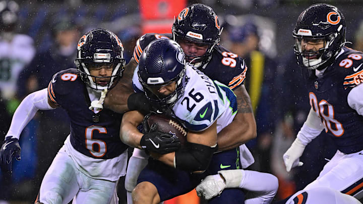 Dec 26, 2024; Chicago, Illinois, USA; Seattle Seahawks running back Zach Charbonnet (26) is tackled after a run against the Chicago Bears during the third quarter at Soldier Field.