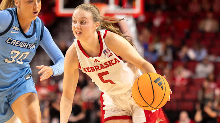 Nebraska guard Claire Johnson drives by Creighton guard Norah Gessert.