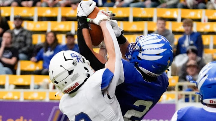 Remsen St. Mary's Keaton Harpenau (2) intercept’s a pass meant for Gladbrook-Reinbeck’s Hudson Clark (3) during the Iowa high school 8-player championship Thursday, Nov. 21, 2024 at the UNI-Dome in Cedar Falls, Iowa.