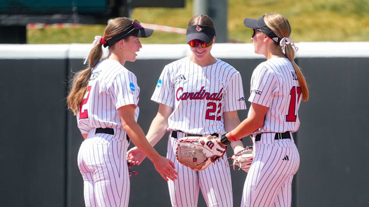 May 15, 2026; Louisville Cardinals left fielder Madison Pickens (2), right fielder Jordan Williams (22) and center fielder Chelsea Mack (10) talk before the start of the game against the Grand Canyon Antelope at Bowlin Stadium in Lincoln, NE, USA;  Mandatory Credit: Dylan Widger-Imagn Images
