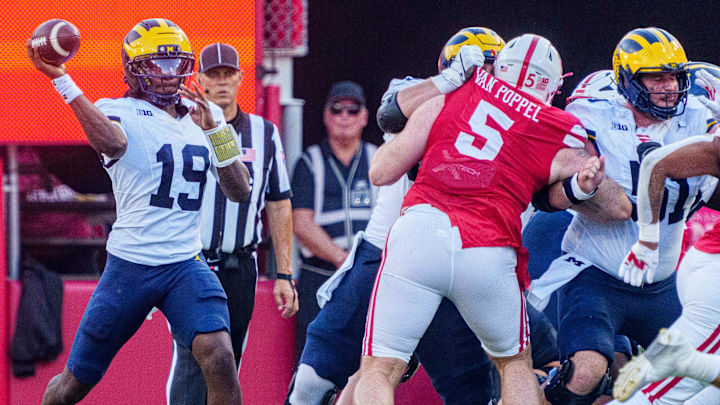 Nebraska defensive lineman Riley Van Poppel tries to put pressure on Michigan quarterback Bryce Underwood at Memorial Stadium. 