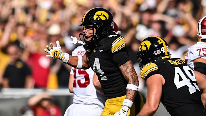 Sep 27, 2025; Iowa City, Iowa, USA; Iowa Hawkeyes defensive back Koen Entringer (4) and defensive lineman Ethan Hurkett (49) and teammates react after a 4th down stop against the Indiana Hoosiers during the second quarter at Kinnick Stadium. Mandatory Credit: Jeffrey Becker-Imagn Images