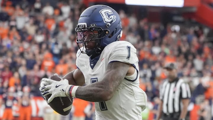 Sep 6, 2025; Syracuse, New York, USA; UConn Huskies wide receiver Skyler Bell (1) runs after making a catch against the Syracuse Orange during overtime at JMA Wireless Dome. Mandatory Credit: Gregory Fisher-Imagn Images