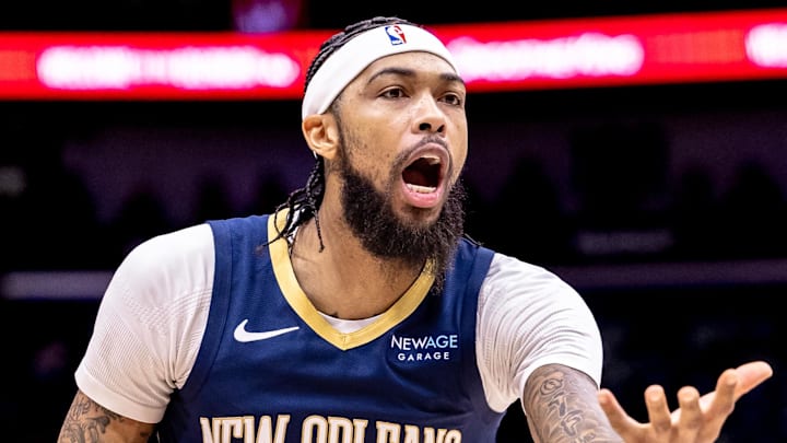 Dec 5, 2024; New Orleans, Louisiana, USA;  New Orleans Pelicans forward Brandon Ingram (14) reacts to a play against Phoenix Suns guard Devin Booker (1) during the first half  at Smoothie King Center. Mandatory Credit: Stephen Lew-Imagn Images