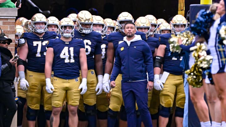 Nov 16, 2024; South Bend, Indiana, USA; Notre Dame Fighting Irish head coach Marcus Freeman prepares to lead his players onto the field for the game against the Virginia Cavaliers at Notre Dame Stadium. 