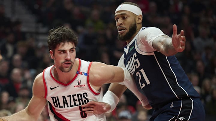 Dec 28, 2024; Portland, Oregon, USA; Portland Trail Blazers forward Deni Avdija (8) drives past Dallas Mavericks center Daniel Gafford (21) during the first half at Moda Center. Mandatory Credit: Troy Wayrynen-Imagn Images