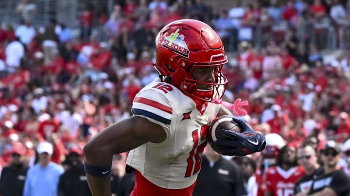 Oct 18, 2025; Houston, Texas, USA; Arizona Wildcats wide receiver Tre Spivey (12) runs the ball in for a touchdown during the fourth quarter against the Houston Cougars at TDECU Stadium. Mandatory Credit: Maria Lysaker-Imagn Images Oct 18, 2025; Houston, Texas, USA; Arizona Wildcats wide receiver Tre Spivey (12) runs the ball in for a touchdown during the fourth quarter against the Houston Cougars at TDECU Stadium. Mandatory Credit: Maria Lysaker-Imagn Images