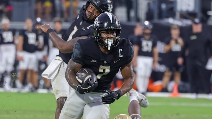 Sep 28, 2024; Orlando, Florida, USA; UCF Knights running back RJ Harvey (7) runs the ball during the second half against the Colorado Buffaloes at FBC Mortgage Stadium. Mandatory Credit: Mike Watters-Imagn Images