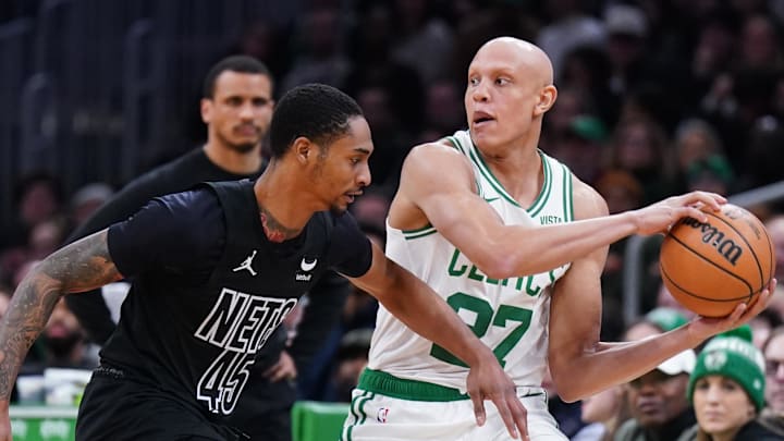 Feb 14, 2024; Boston, Massachusetts, USA; Boston Celtics guard Jordan Walsh (27) grabs the loose ball against Brooklyn Nets guard Keon Johnson (45) in the second half at TD Garden. Mandatory Credit: David Butler II-USA TODAY Sports