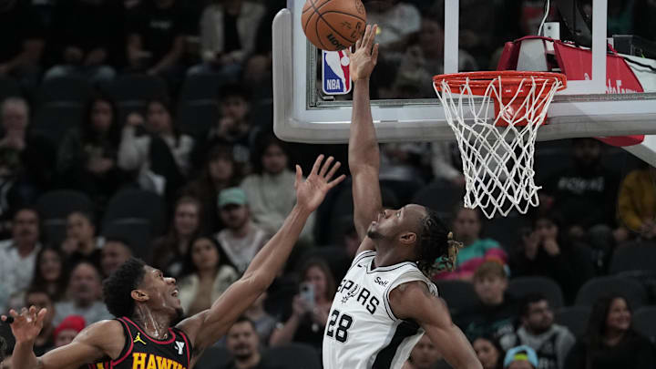 Nov 30, 2023; San Antonio, Texas, USA;  San Antonio Spurs center Charles Bassey (28) blocks a shot by Atlanta Hawks forward De'Andre Hunter (12) in the first half at the Frost Bank Center. Mandatory Credit: Daniel Dunn-Imagn Images