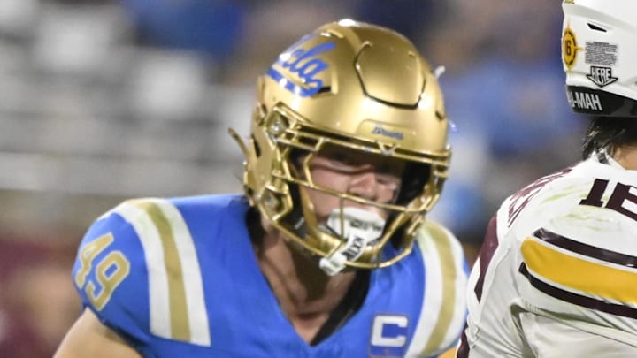 Oct 12, 2024; Pasadena, California, USA; Minnesota Golden Gophers quarterback Max Brosmer (16) scrambles out of the pocket against UCLA Bruins linebacker Carson Schwesinger (49) and defensive lineman Siale Taupaki (92) during the third quarter at Rose Bowl. Mandatory Credit: Robert Hanashiro-Imagn Images