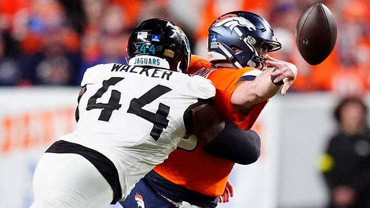 Dec 21, 2025; Denver, Colorado, USA; Jacksonville Jaguars defensive end Travon Walker (44) hits Denver Broncos quarterback Bo Nix (10) during the second half at Empower Field at Mile High. Mandatory Credit: Ron Chenoy-Imagn Images