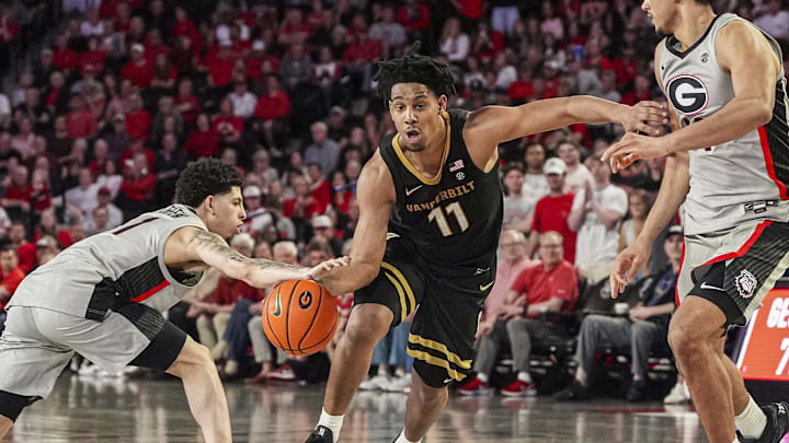 Vanderbilt Commodores guard AJ Hoggard (11) dribbles defended by Georgia Bulldogs guard Dakota Leffew (1) and forward Asa Newell (14) during the second half at Stegeman Coliseum. Vanderbilt Commodores guard AJ Hoggard (11) dribbles defended by Georgia Bulldogs guard Dakota Leffew (1) and forward Asa Newell (14) during the second half at Stegeman Coliseum.