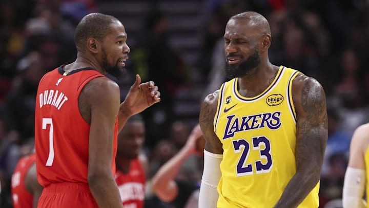 Mar 16, 2026; Houston, Texas, USA; Houston Rockets forward Kevin Durant (7) talks with Los Angeles Lakers forward LeBron James (23) on the court during the second quarter at Toyota Center. Mandatory Credit: Troy Taormina-Imagn Images