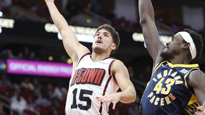 Nov 20, 2024; Houston, Texas, USA; Houston Rockets guard Reed Sheppard (15) shoots the ball as Indiana Pacers forward Pascal Siakam (43) defends during the second quarter at Toyota Center. Mandatory Credit: Troy Taormina-Imagn Images