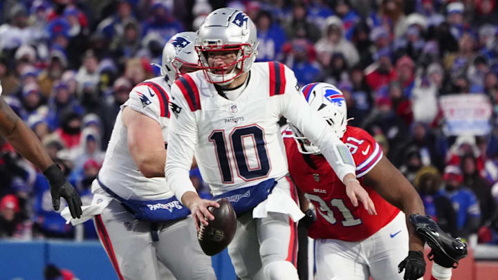 Dec 22, 2024; Orchard Park, New York, USA; New England Patriots quarterack Drake Maye (10) runs with the ball against the Buffalo Bills during the first half at Highmark Stadium. Mandatory Credit: Gregory Fisher-Imagn Images