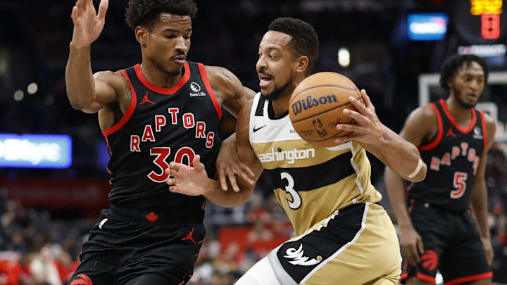 Dec 26, 2025; Washington, District of Columbia, USA; Washington Wizards guard CJ McCollum (3) drives to the basket as Toronto Raptors guard Ochai Agbaji (30) defends in the second half at Capital One Arena. Mandatory Credit: Geoff Burke-Imagn Images