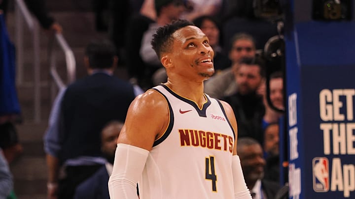 Mar 17, 2025; San Francisco, California, USA;  Denver Nuggets guard Russell Westbrook (4) smiles ahead of a sign reading “Russ” after a play against the Golden State Warriors during the fourth quarter at Chase Center. Mandatory Credit: Kelley L Cox-Imagn Images