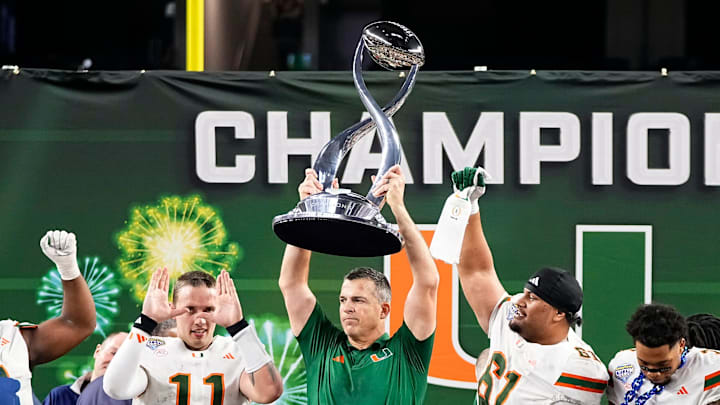 Miami Hurricanes head coach Mario Cristobal hoists the Field Scovell Trophy following the Cotton Bowl at AT&T Stadium in Arlington, Texas for the College Football Playoff quarterfinal game against the Ohio State Buckeyes on Dec. 31, 2025. Ohio State lost 24-14.