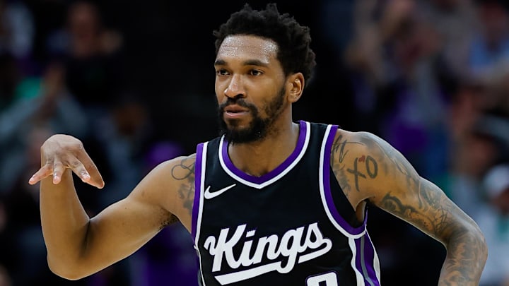 Mar 17, 2025; Sacramento, California, USA; Sacramento Kings guard Malik Monk (0) celebrates after scoring a basket against the Memphis Grizzlies during the fourth quarter at Golden 1 Center. Mandatory Credit: Sergio Estrada-Imagn Images