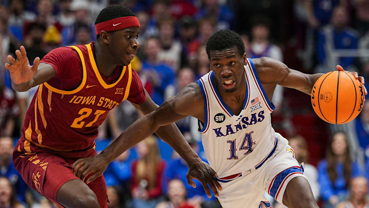 Jan 13, 2026; Lawrence, Kansas, USA; Kansas Jayhawks guard Melvin Council Jr. (14) drives against Iowa State Cyclones guard Killyan Toure (27) during the second half at Allen Fieldhouse.
