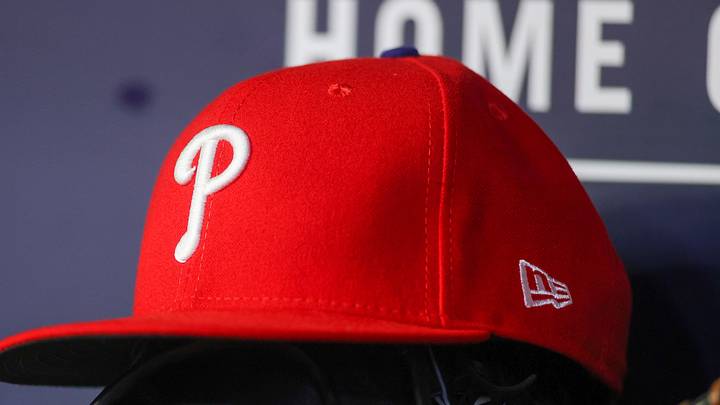 May 26, 2023; Atlanta, Georgia, USA; A detailed view of a Philadelphia Phillies hat and glove on the bench against the Atlanta Braves in the seventh inning at Truist Park. 