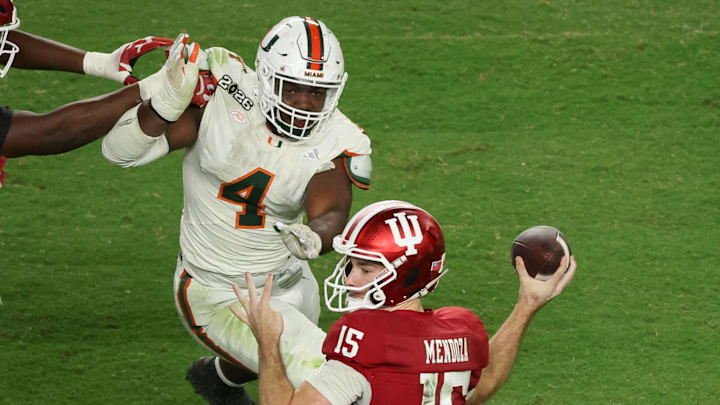 Jan 19, 2026; Miami Gardens, FL, USA; Indiana Hoosiers quarterback Fernando Mendoza (15) passes the ball under pressure by Miami Hurricanes defensive lineman Rueben Bain Jr. (4) in the third quarter during the College Football Playoff National Championship game at Hard Rock Stadium. Mandatory Credit: Kim Klement Neitzel-Imagn Images