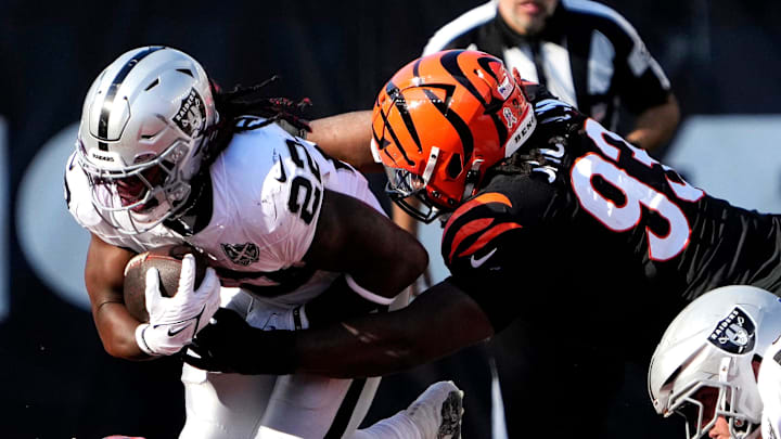 Cincinnati Bengals defensive tackle McKinnley Jackson (93) tackles Las Vegas Raiders running back Alexander Mattison (22) in the 3rd quarter at Paycor Stadium Sunday, November 3, 2024. Cincinnati Bengals defensive tackle McKinnley Jackson (93) tackles Las Vegas Raiders running back Alexander Mattison (22) in the 3rd quarter at Paycor Stadium Sunday, November 3, 2024.