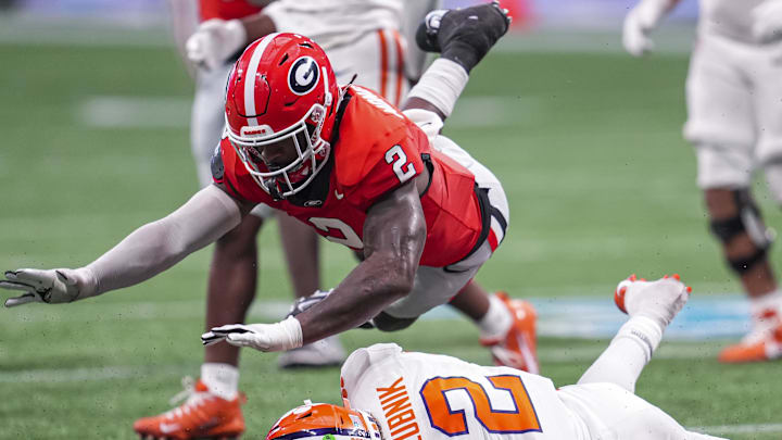 Aug 31, 2024; Atlanta, Georgia, USA; Georgia Bulldogs linebacker Smael Mondon Jr. (2) flies over Clemson Tigers quarterback Cade Klubnik (2) during the second half at Mercedes-Benz Stadium. Mandatory Credit: Dale Zanine-Imagn Images