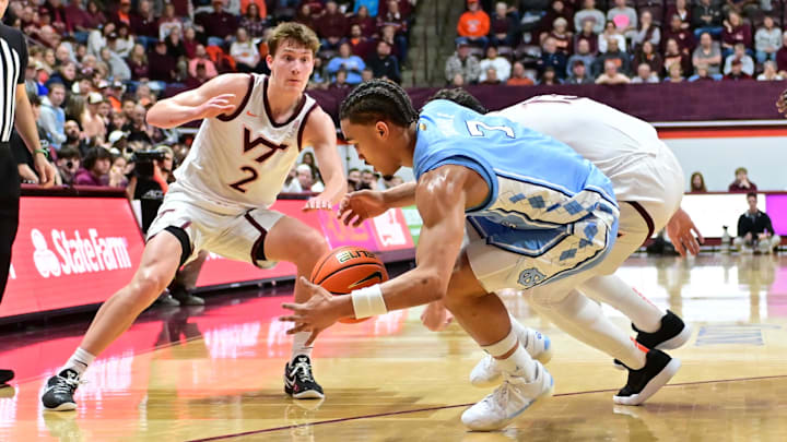 Mar 4, 2025; North Carolina guard Elliot Cadeau (3), Virginia Tech guard Jaden Schutt (2) and forward Ben Burnham (13) go after a loose ball.