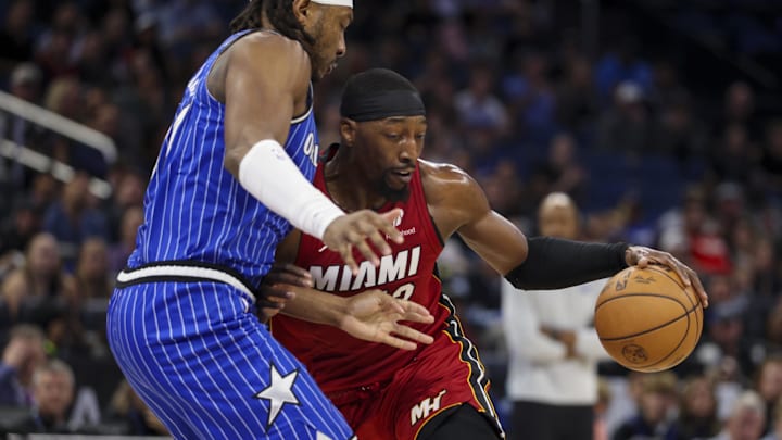 Dec 5, 2025; Orlando, Florida, USA; Miami Heat center Bam Adebayo (13) drives to the hoop past Orlando Magic center Wendell Carter Jr. (34) in the first quarter at Kia Center. Mandatory Credit: Nathan Ray Seebeck-Imagn Images