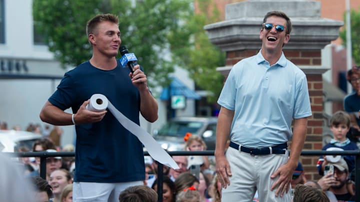 Former Auburn quarterback Bo Nix shows Eli Manning the proper technique to throwing roll Toomers during the filming of the ESPN show Eli’s Places at Toomer’s Corner in Auburn, Ala. on Tuesday, July 8, 2025.